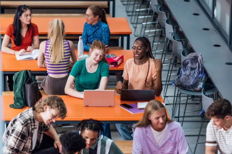 A group of students working together in a school common room.