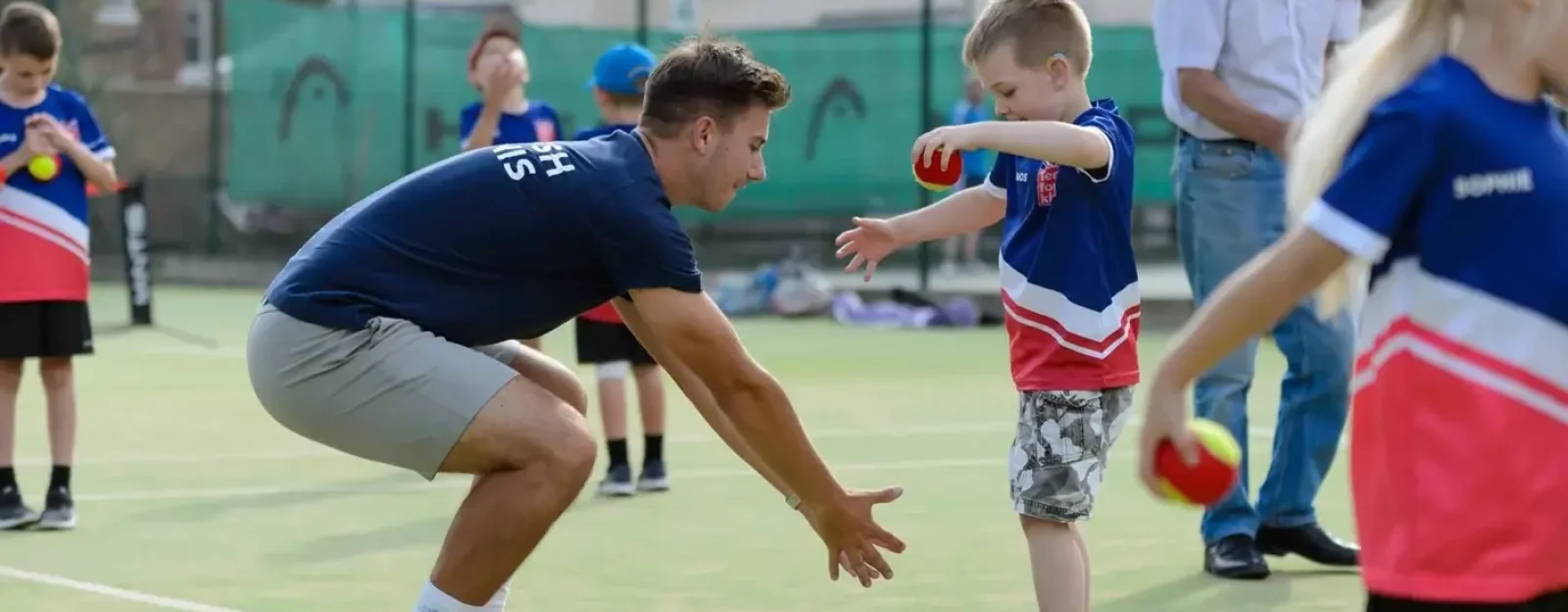 A coaching assistant working with a child