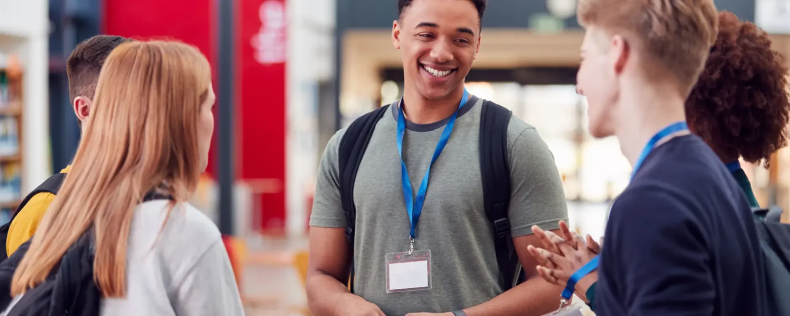 A group of college students meeting up and talking in a communal area